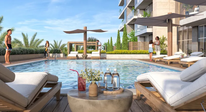 Swimming pool with loungers and shade parasols beside the Verdana VII apartments (developer render)