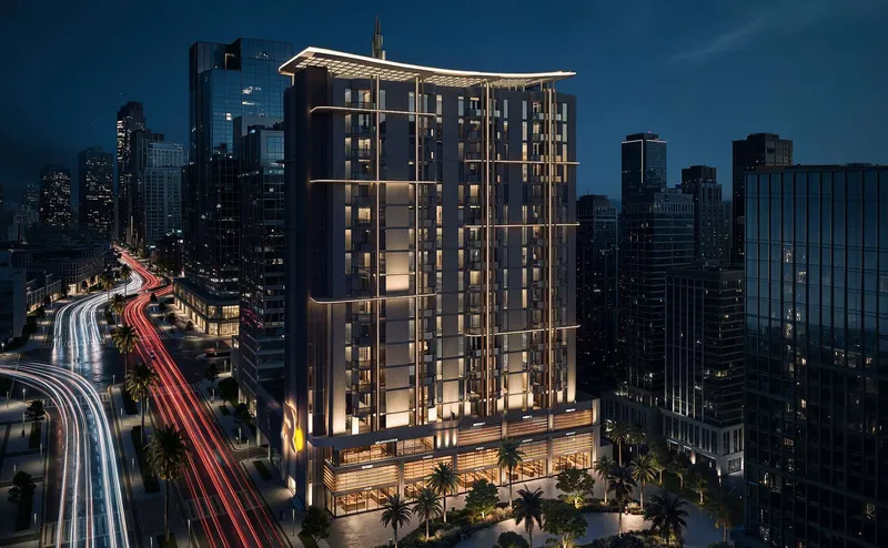 Verso by Reportage tower lit at night above its retail podium (developer render)