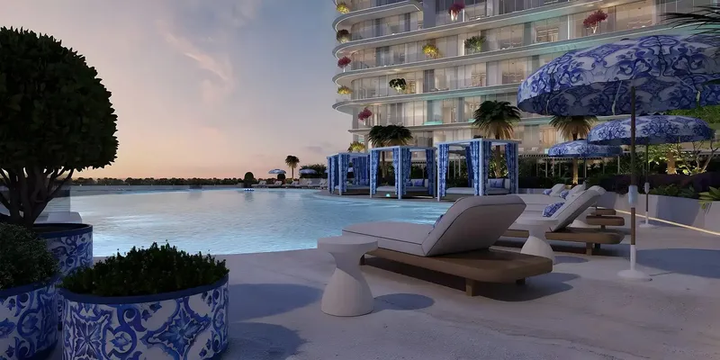 Pool deck with blue-and-white parasols and sun loungers at Villa del Garda