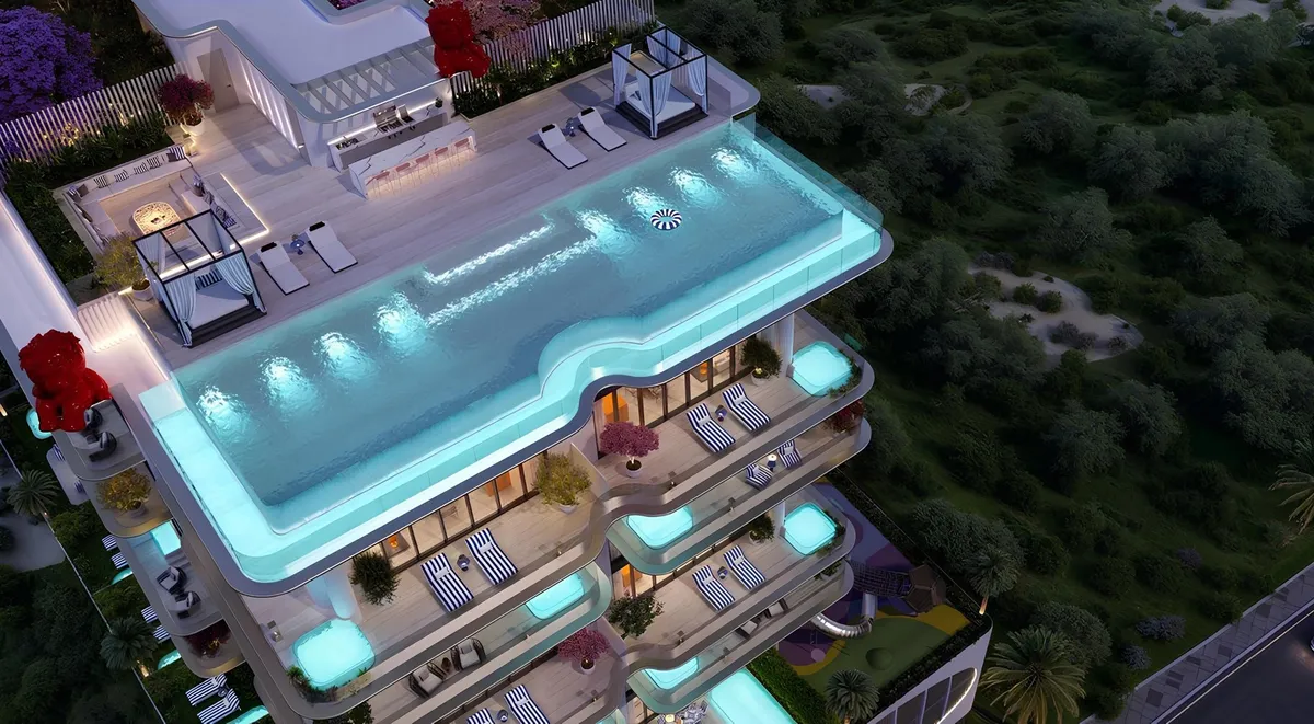 Aerial view of the rooftop infinity pool and cabanas of Villa dell'Arte at night