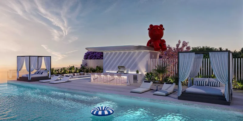 Rooftop pool deck with cabanas and a bar at Villa dell'Arte at sunset
