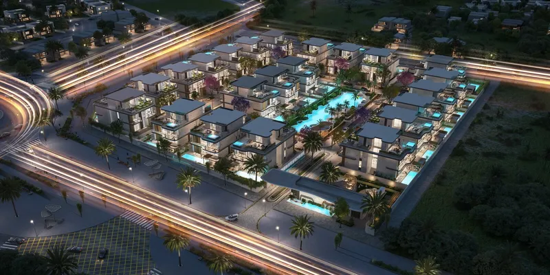 Aerial dusk render of Wellington Grand Villas in MBR City District 11, with lit villas around a central lagoon