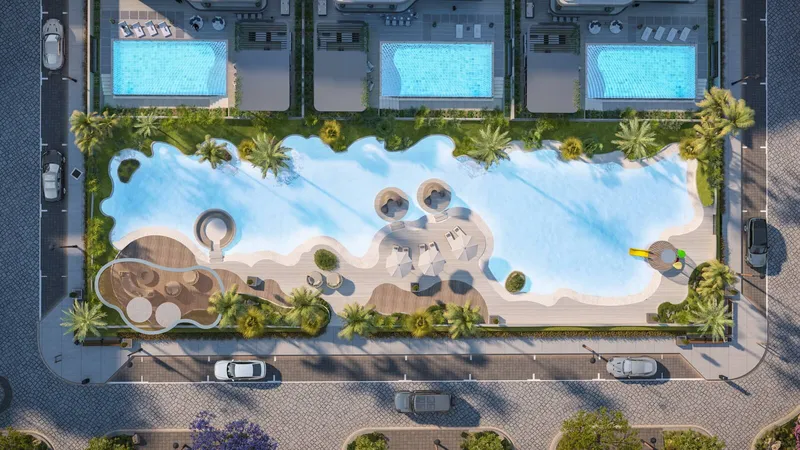 Overhead render of the lagoon at Wellington Grand Villas with its sand edge, shaded seating and the private pools of three villas behind