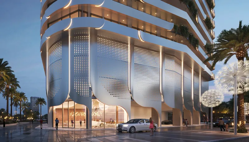 Evening render of the perforated, petal-shaped podium panels and glazed entrance of Weybridge Gardens 4