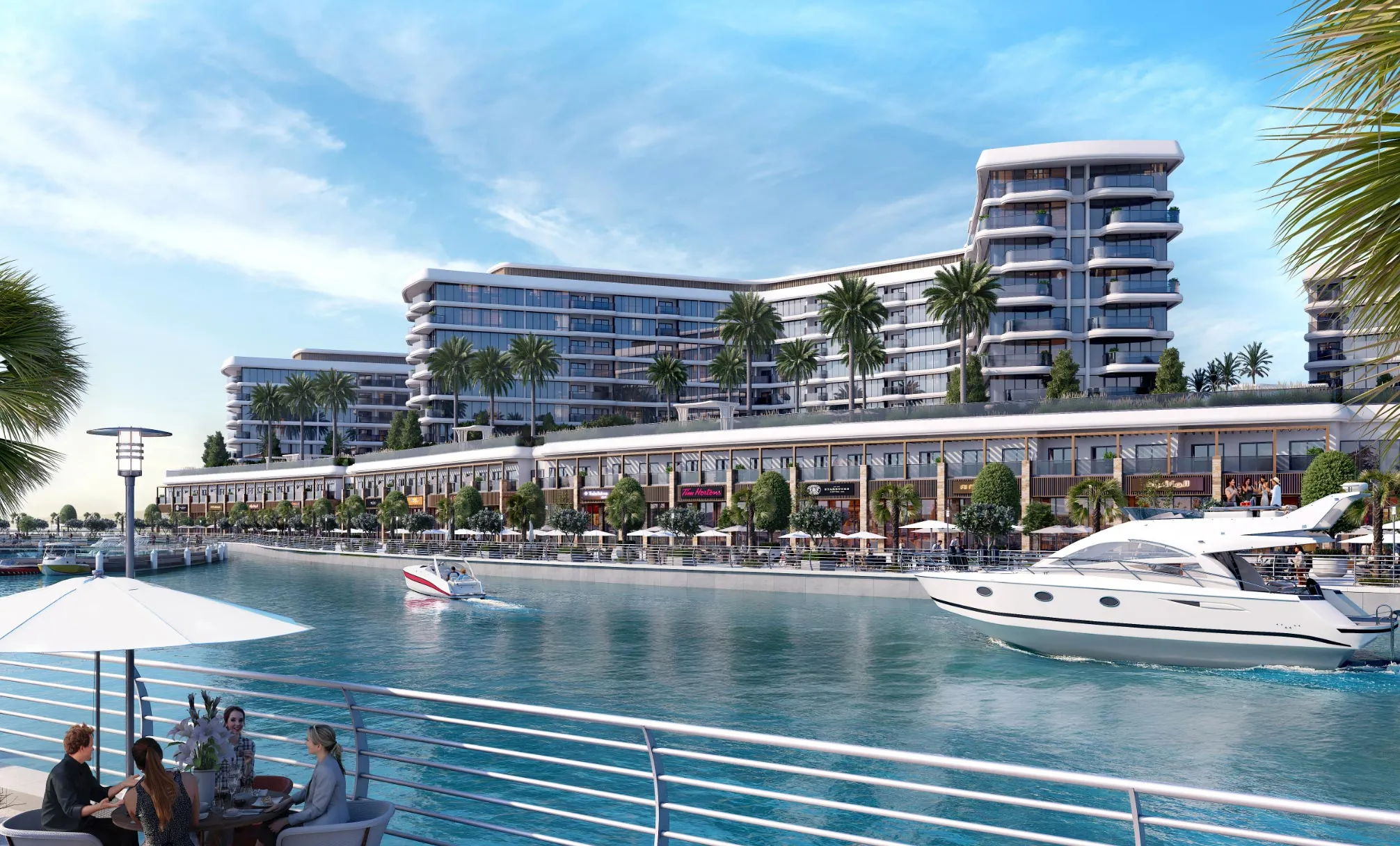 Yachtside Marina Residences above a row of waterfront shops on the canal of Sobha Siniya Island, with yachts passing