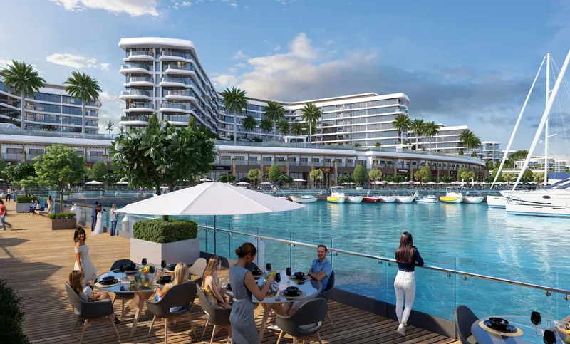 Yachtside Marina Residences seen from the waterfront promenade, with boats moored along the quay