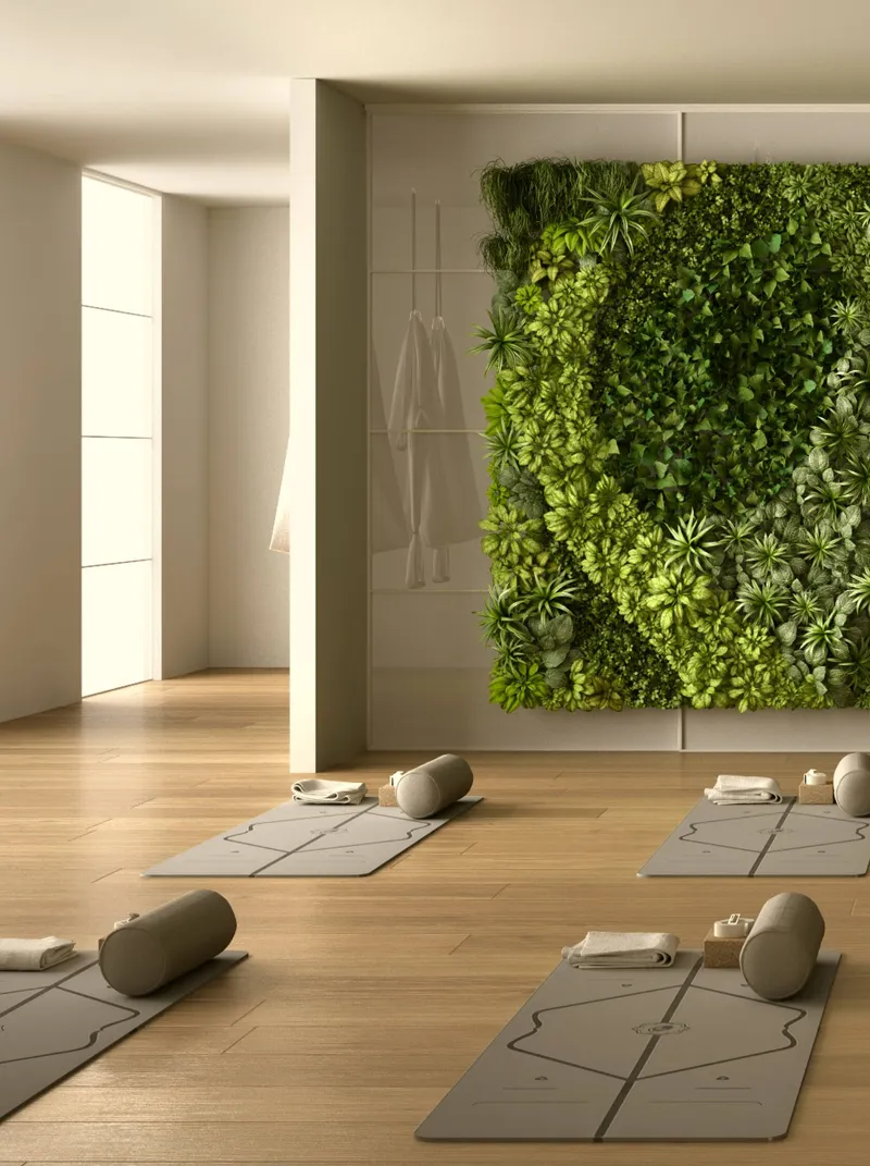Yoga and meditation room at Zephyra Residences with mats and a green wall