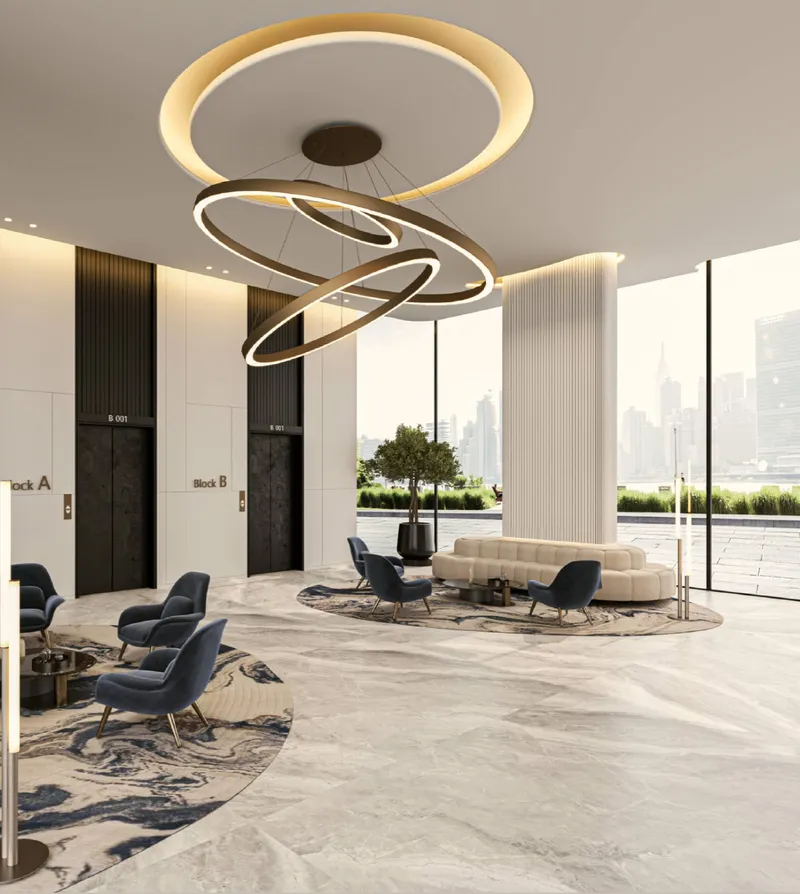 Double-height lobby at Zephyra Residences with ring pendant lights and lounge seating